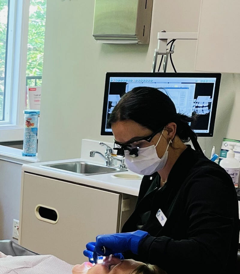 Greenwood Dental Smiles Assistant Performing Teeth Whitening